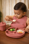 Dhootha™ 6-in-1 Silicone Baby Feeding Set with Suction Plate, Bowl, Cup, Bib, Spoon & Fork | BPA-Free Self Feeding Essentials for Babies 6–12 Months | Dark Pink